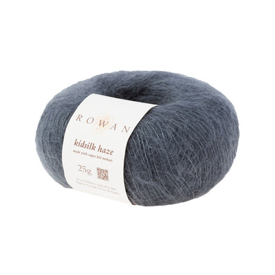 A skein of Rowan Kidsilk Haze yarn in dark gray color with a label wrapped around it.