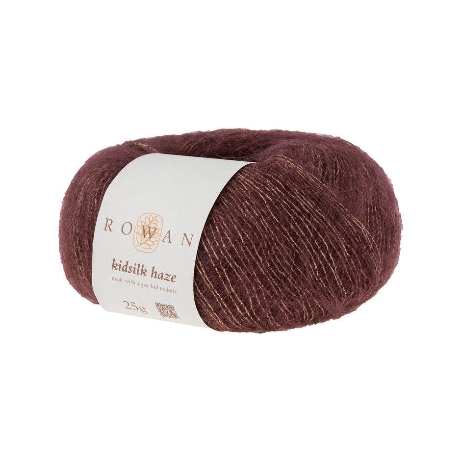 A skein of Rowan Kidsilk Haze yarn in dark brown color with a label wrapped around it.