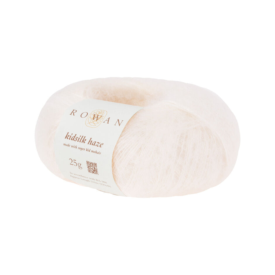 A skein of Rowan Kidsilk Haze yarn in cream color with a label wrapped around it.