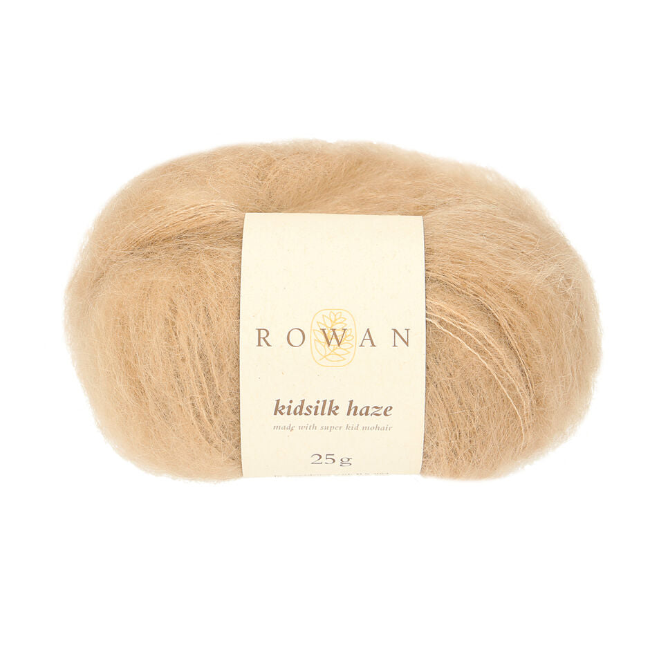 A skein of Rowan Kidsilk Haze yarn in a beige color with a label wrapped around it.