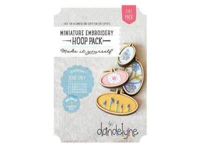 Packaging of Dandelyne Oval Mini Hoop (set of 4) with miniature hoops displayed in a clear window, accompanied by small decorative items like screws, bolts, backing pieces, and center plates.