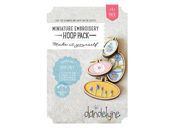 Packaging of Dandelyne Oval Mini Hoop (set of 4) with miniature hoops displayed in a clear window, accompanied by small decorative items like screws, bolts, backing pieces, and center plates.