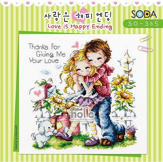 A charming, square-format cross-stitch kit from SODA (Korea) titled 'Love is Happy Ending.' The design features a whimsical and romantic illustrative scene with a sweet couple and heart motifs. The kit includes 14-count white Aida cloth, full skeins of DMC embroidery threads, and a needle. The stitch count is 106 stitches wide by 108 stitches high