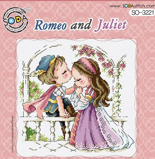 Cross stitch kit depicting a scene of 'Romeo and Juliet' with the characters embracing from behind a balcony, surrounded by a pink floral pattern.