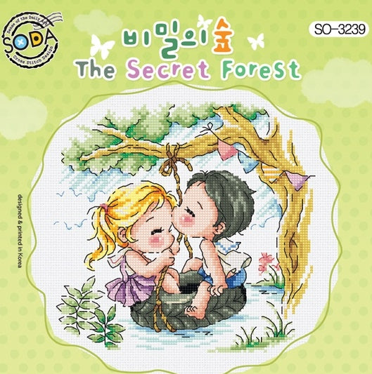 A square-format cross-stitch kit from SODA (Korea) titled 'Secret Forest.' The design features a whimsical illustration of a dense, magical forest with a couple enjoying their time in nature. The kit includes 14-count white Aida cloth, full skeins of DMC embroidery threads, and a needle. The finished design measures 18.5 cm by 18 cm.