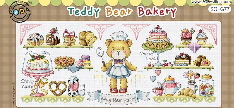 A large, panoramic cross-stitch kit from Korean brand SODA featuring the 'Teddy Bear Bakery.' The design showcases several adorable teddy bears baking bread, cakes, and pastries in a highly detailed bakery setting. The kit includes 18-count white Aida cloth, full skeins of DMC embroidery threads, and a needle for a finished design measuring 278 by 115 stitches.