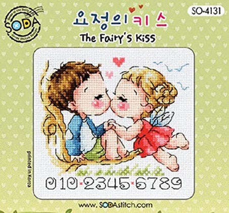A cross stitch kit packaging featuring an illustration of a fairy kissing a human male on the front, with a green background and heart decorations.