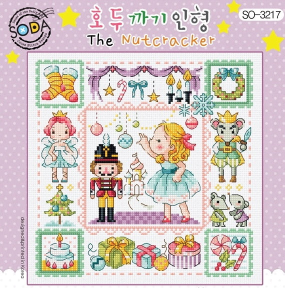 Cross stitch kit depicting 'The Nutcracker' with various colorful characters and motifs on a white background.