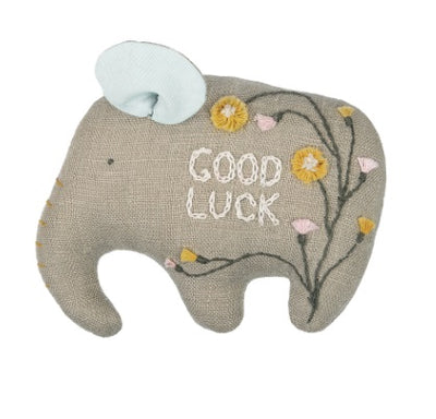 A sewing kit depicting a grey elephant with embroidery flowers on the back with the words" GOOD LUCK"