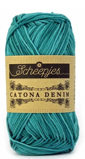 A 50g ball of Scheepjes Catona Denim yarn, showing the 100% natural cotton fibers with a subtle, variegated denim-effect jade/green colorway