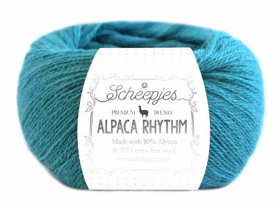 A skein of Scheepjes Alpaca Rhythm yarn in a multicolor pattern, with the brand and product name displayed on the label in teal blue colour