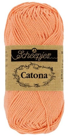 Close-up of Scheepjes Catona 50g cotton showing the smooth, fuzz-free texture and vibrant Apricot Color tone for high-definition stitch work
