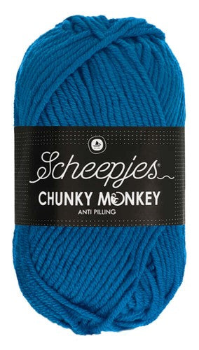 A lush, oversized ball of Scheepjes Chunky Monkey Aran yarn in a vibrant solid color, featuring a thick, smooth twist and a subtle silky sheen in Ultramarine colour