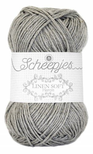 A skein of Scheepjes Linen Soft yarn in grey silver color, with brand label visible.