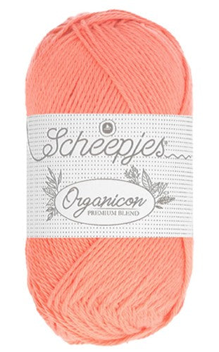 Close-up of the Scheepjes Organicon fibers, highlighting the clean, high-quality plies of sustainable cotton. in coral orange olour.