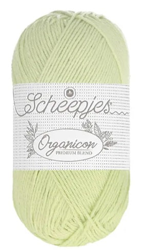 A 50g ball of Scheepjes Organicon yarn in a soft pastel shade, showcasing its smooth matte finish and 100% organic cotton texture in sweet apple green colour