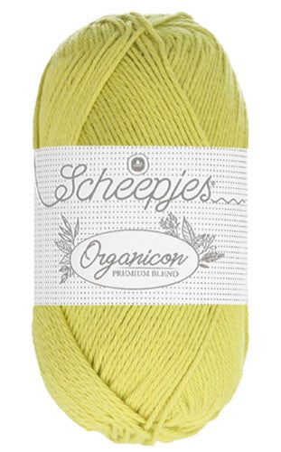 "A 50g ball of Scheepjes Organicon yarn in a soft pastel shade, showcasing its smooth matte finish and 100% organic cotton texture in spring green