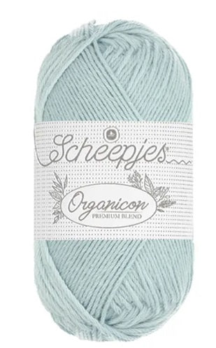 A 50g ball of Scheepjes Organicon yarn in a soft pastel shade, showcasing its smooth matte finish and 100% organic cotton texture in soft sky blue colour