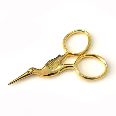 A pair of miniature 'Storklette' embroidery scissors, featuring the classic bird-shaped design in a compact 40x70mm size. Shown in various vibrant and metallic finishes, these stainless steel scissors highlight their sharp precision tips and portable scale, perfect for travel sewing kits.