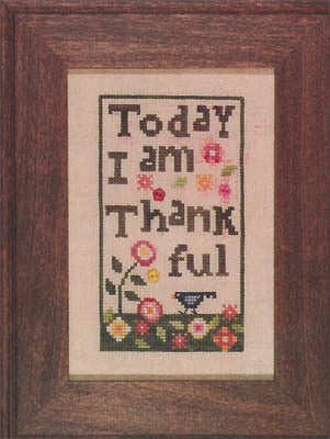 A professional cross-stitch chart for an inspirational sampler titled 'Thankful.' The design features the elegant text 'Today I am thankful' surrounded by delicate folk-art motifs. The kit includes the paper chart with clear symbols and thread suggestions, as well as a set of three coordinating decorative buttons to be used as embellishments.