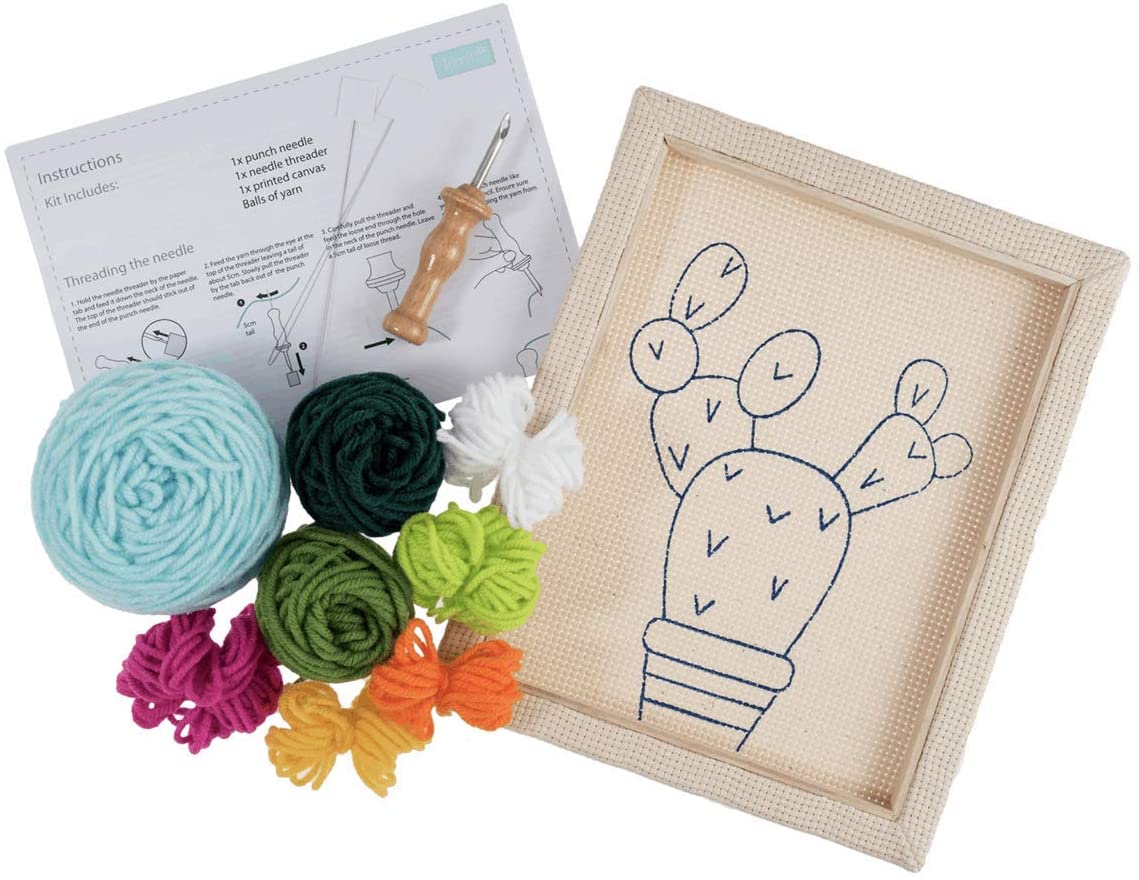 The kit includes a 20.32 x 25.4 cm (8x10 inch) fabric panel pre-stretched on a wooden frame with a printed cactus outline. Also included are vibrant green and terracotta yarns, a punch needle tool, a needle threader, and a large color reference image