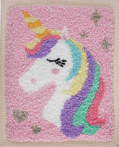 A magical 'Unicorn' punch needle starter kit by Trimits. The kit includes an 8x10 inch fabric panel pre-stretched on a wooden frame with a printed unicorn silhouette. It features a palette of pastel and vibrant yarns, a specialized punch needle tool, a needle threader, and a large color image for easy reference.