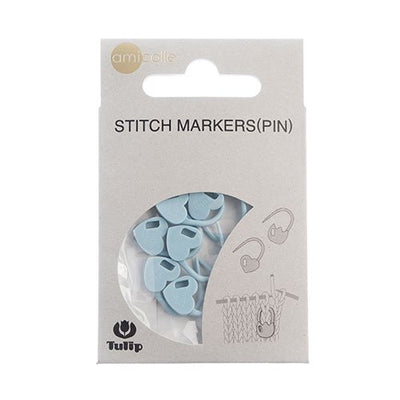 A pack of 7 premium Tulip stitch markers from Japan, available in blue heart shapes. The markers feature a secure, clip-on design with a smooth finish to prevent snagging on yarn. They come in soft, vibrant colors and are displayed in their original Tulip Japan packaging, perfect for marking rows on sweaters and tops.