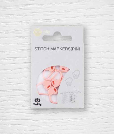Pack of pink heart-shaped stitch markers on a card, with the brand name 'Tulip' visible.