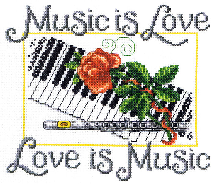 A complete cross-stitch kit designed by Ursula Michael titled 'Music is Love.' The design is a sophisticated musical sampler featuring a piano keyboard, a detailed flute, and a single red rose.