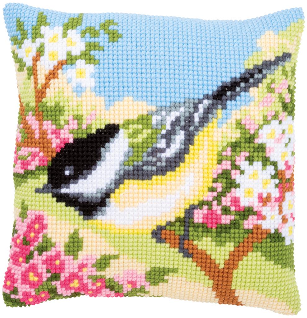 A Vervaco needlepoint kit titled 'Bird in the Garden.' The design features a colorful bird perched among blooming garden flowers and lush greenery. The kit includes a premium large-hole Zweigart canvas with the design hand-painted on the weave, soft acrylic yarn, and a tapestry needle for a 40cm x 40cm decorative cushion front.