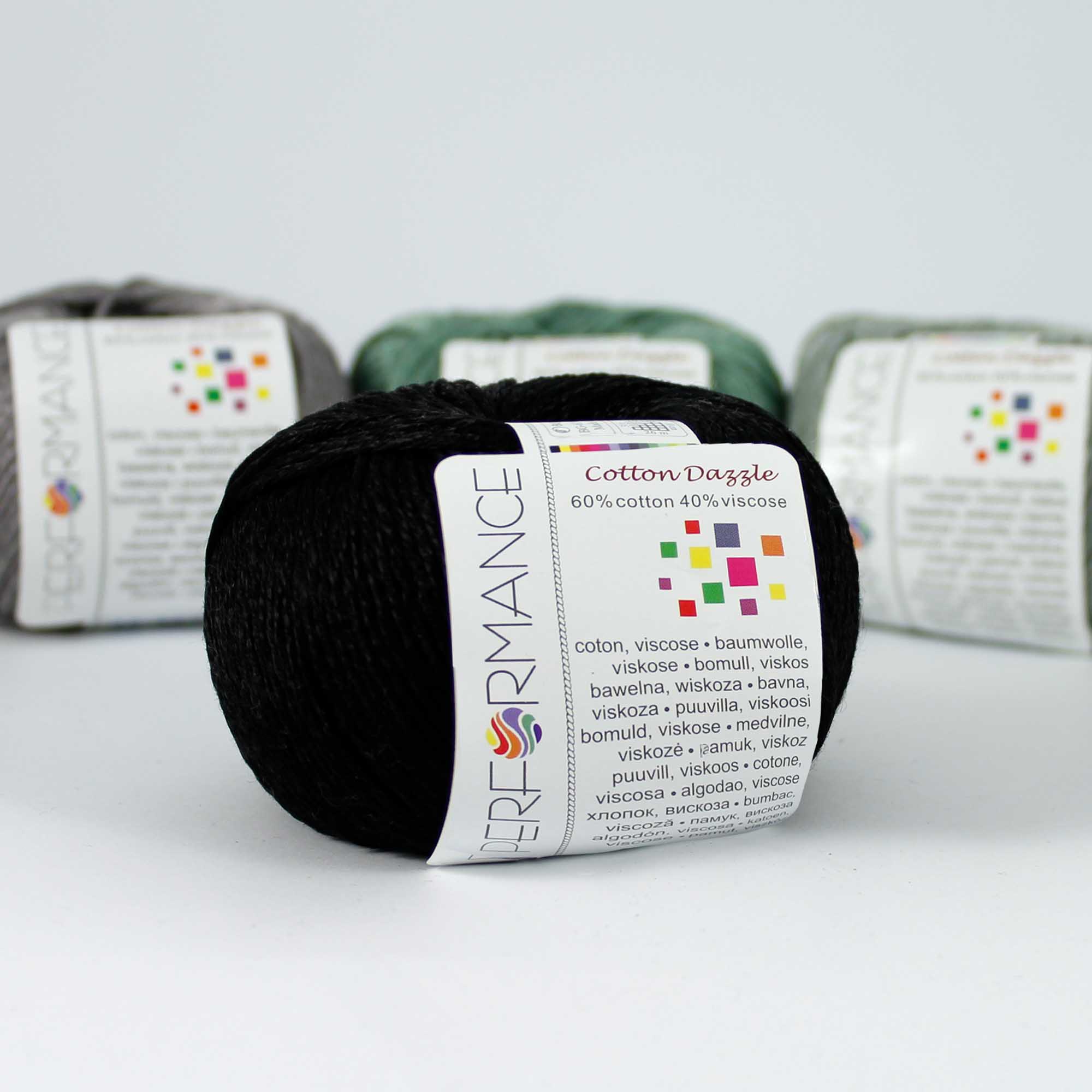 A 50g skein of Cotton Dazzle yarn in a black vibrant shade, showcasing the subtle reflective shimmer and smooth plied texture of the cotton-viscose blend