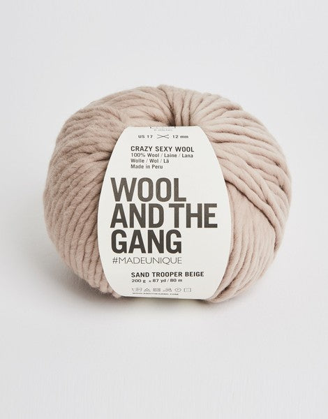 A giant 200g ball of Wool and the Gang Crazy Sexy Wool, showcasing its thick, plump, and ultra-soft 100% Peruvian wool fibers in Beige colour