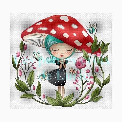 A cross stitch kit depicting a girl with a blue hat and dress, standing under a red mushroom, surrounded by greenery and butterflies.