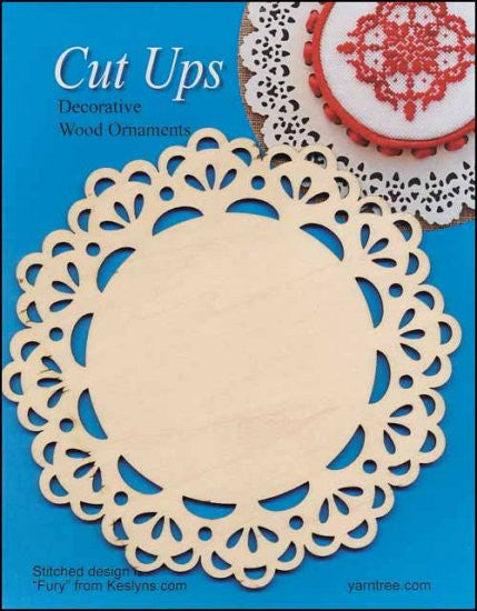 A circular cut-up decorative wood ornament with a lace pattern design, displayed against a blue background with a completed ornament in the top right corner.
A wood lace ornament being customized with colorful embroidery thread woven through the geometric cutouts