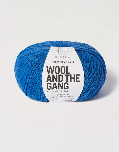 A 100g ball of Wool and the Gang Buddy Hemp yarn, showcasing its natural, matte texture and soft, earthy color palette in Riviera Blue color
