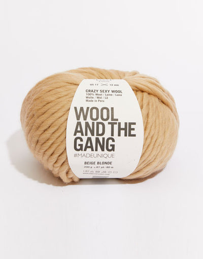 A giant 200g ball of Wool and the Gang Crazy Sexy Wool, showcasing its thick, plump, and ultra-soft 100% Peruvian wool fibers in blonde beige