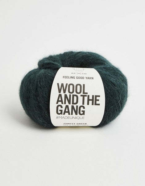 A 50g ball of Wool and the Gang Feeling Good yarn, showing its signature fluffy, brushed texture and voluminous air-blown structure in forest green colour.