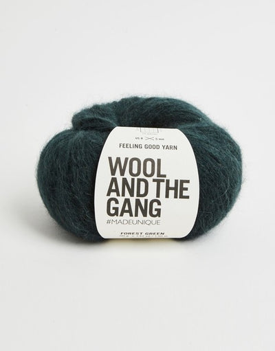 A 50g ball of Wool and the Gang Feeling Good yarn, showing its signature fluffy, brushed texture and voluminous air-blown structure in forest green colour.