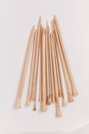 A collection of Maplewood knitting needles by Wool and The Gang, displayed on a white background.
