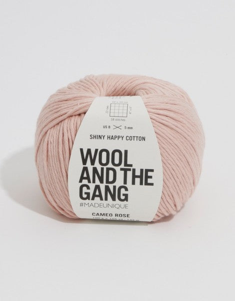 A 100g ball of Wool and the Gang Shiny Happy Cotton yarn in a vibrant mauve shade, showing its smooth texture and subtle natural sheen. Best Cotton Yarn for Summer, Luxury Aran Cotton, WATG Yarn Singapore.