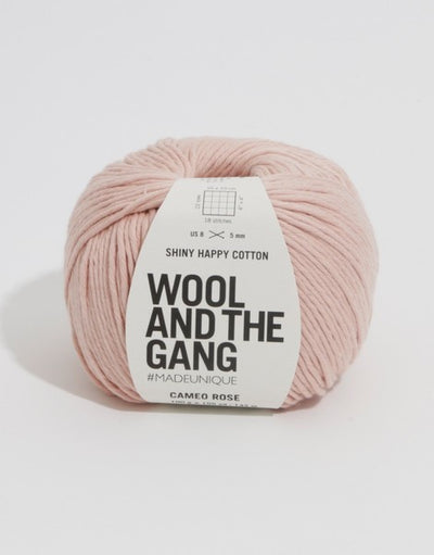 A 100g ball of Wool and the Gang Shiny Happy Cotton yarn in a vibrant mauve shade, showing its smooth texture and subtle natural sheen. Best Cotton Yarn for Summer, Luxury Aran Cotton, WATG Yarn Singapore.