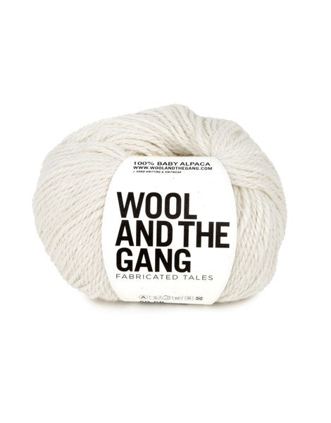 A blue skein of WOOL AND THE GANG Sugar Baby Alpaca yarn with a label in the center in snow white colour.