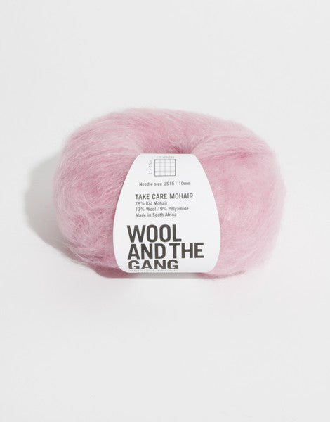 A voluminous 50g ball of Wool and the Gang Take Care Mohair, showing its iconic fluffy halo and soft, radiant fiber texture in bubblegum pink colour.