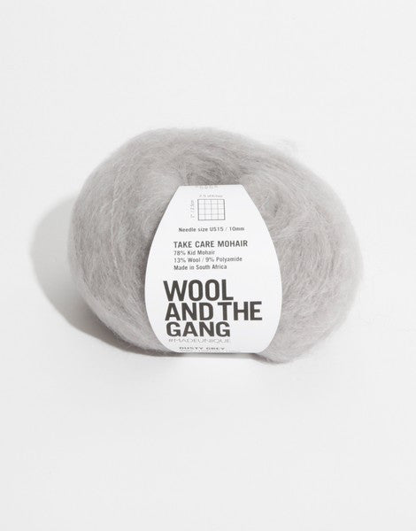 A voluminous 50g ball of Wool and the Gang Take Care Mohair, showing its iconic fluffy halo and soft, radiant fiber texture in dusty grey colour.