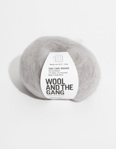 A voluminous 50g ball of Wool and the Gang Take Care Mohair, showing its iconic fluffy halo and soft, radiant fiber texture in dusty grey colour.
