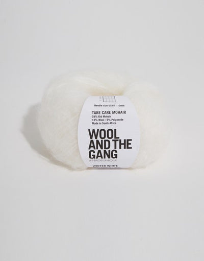 A voluminous 50g ball of Wool and the Gang Take Care Mohair, showing its iconic fluffy halo and soft, radiant fiber texture in winter white colour.