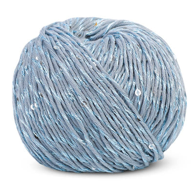 A 50g ball of DMC Natura Glam yarn, showing the beautiful twist of plain cotton thread with a matching sequined strand in baby blue