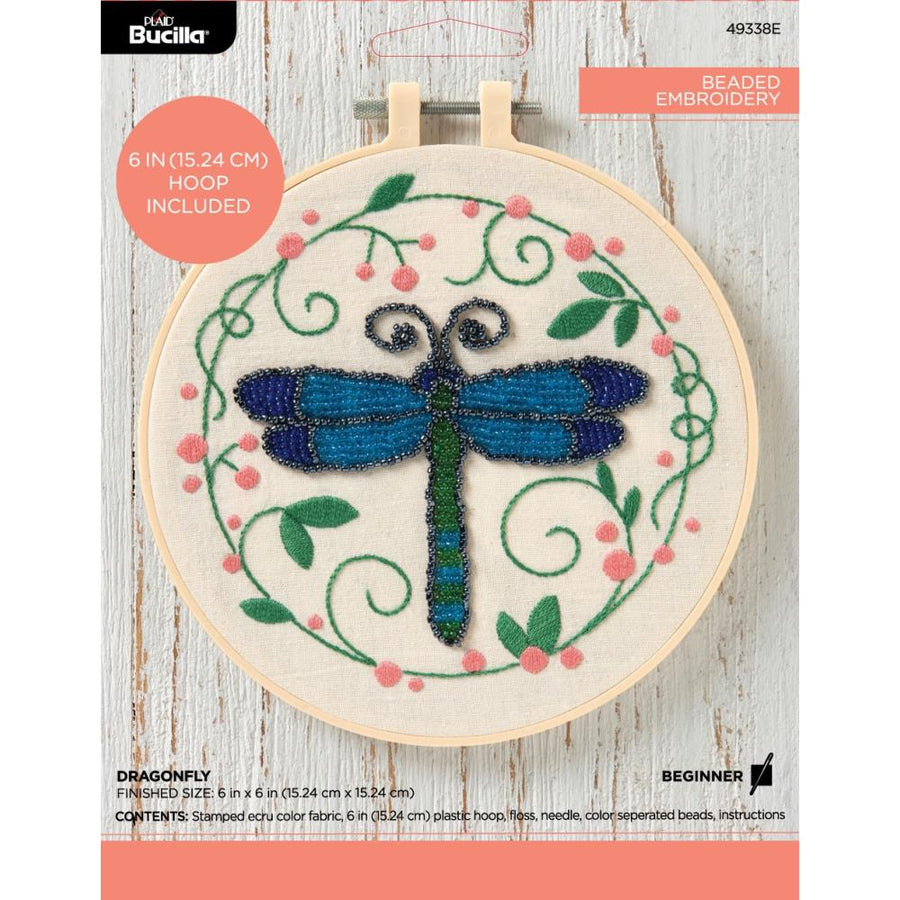 beaded embroidery of a drangonfly with blue wings Bucilla kit with beads on a printed canvas with flora boarders. 