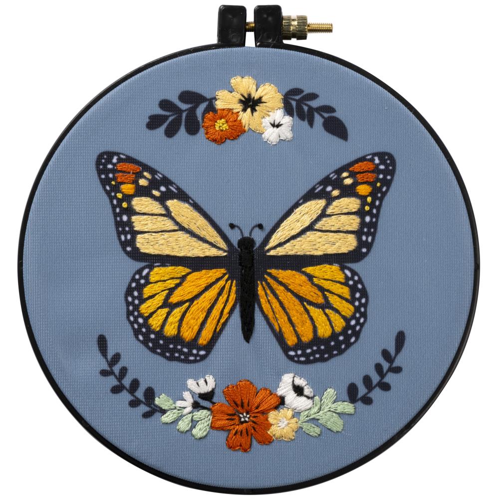 embroidery butterfly in a blue cloth with flora details
