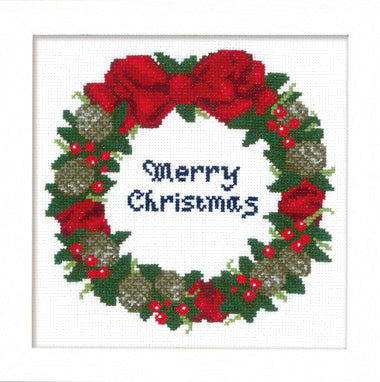 Olympus Japanese cross stitch kit showing a completed Christmas wreath design with red ribbons, green holly, and festive ornaments on a white 13-count fabric background
